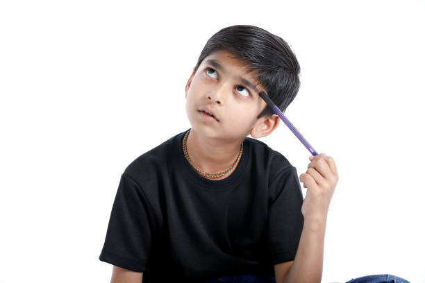 cute indian boy thinking idea and looking at up, isolated on white background - facial expression child asia asian and indian ethnicities imagens e fotografias de stock