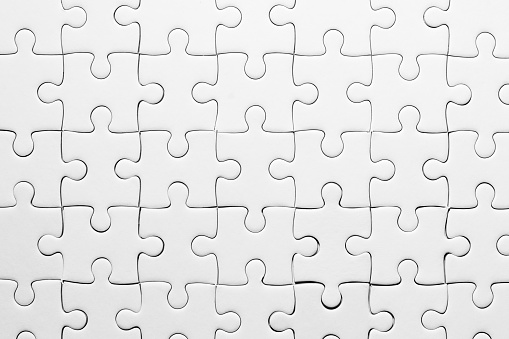 close up pattern of white jigsaw for background
