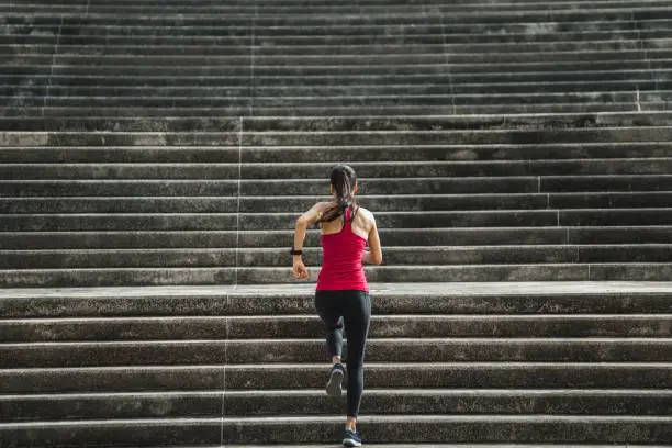 Photo of Fitness woman she is running up the stairs.