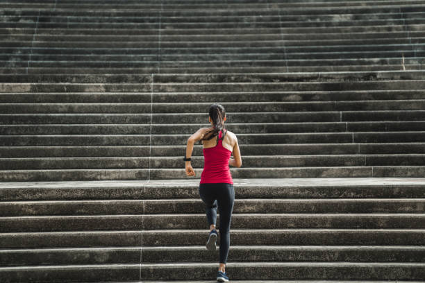 фитнес-женщина она бежит вверх по лестнице. - scoring run стоковые фото и изображения