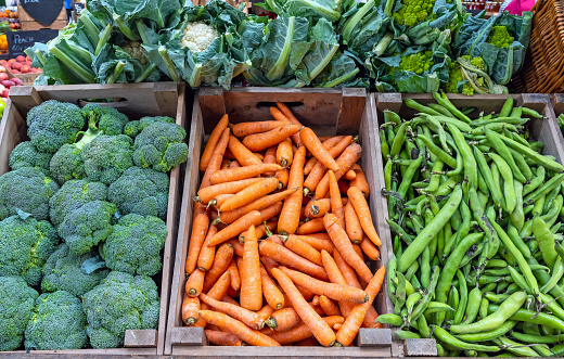 Broccoli, carrots and green peas for sale at a market