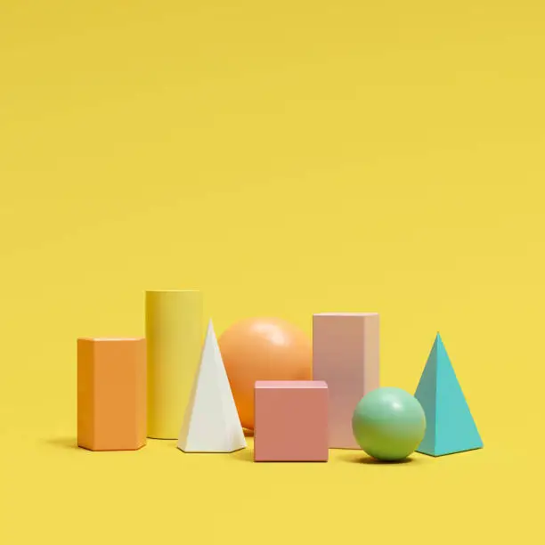 Photo of colorful geometric shapes set on yellow background. minimal concept idea