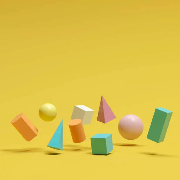 Photo of colorful geometric shapes set floating on yellow background. minimal concept idea