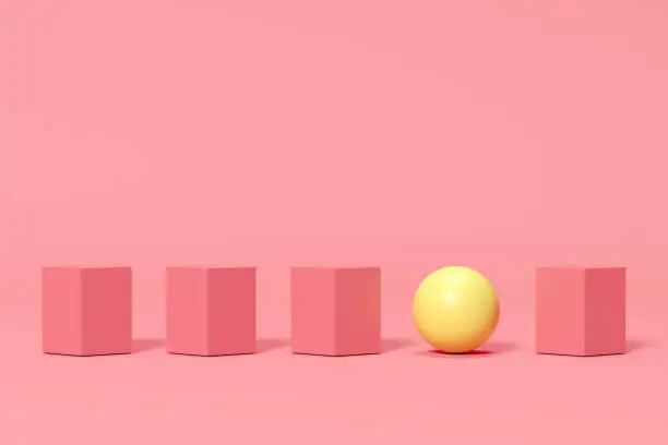 Photo of ourstanding yellow sphere among pink boxes on pink background. minimal concept idea