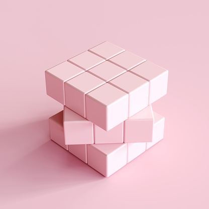 cubo de Rubik de color rosa claro sobre fondo rosa claro. idea de concepto minimalista photo