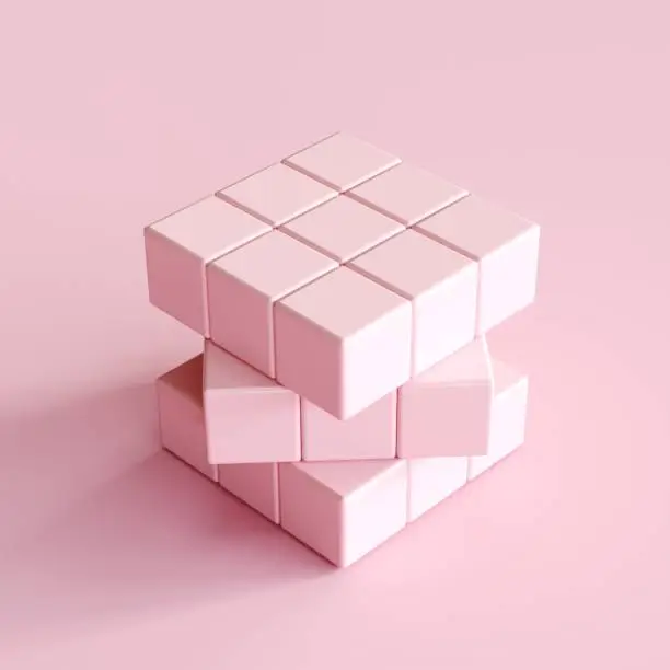 Photo of light pink rubik's cube on light pink background. minimal concept idea
