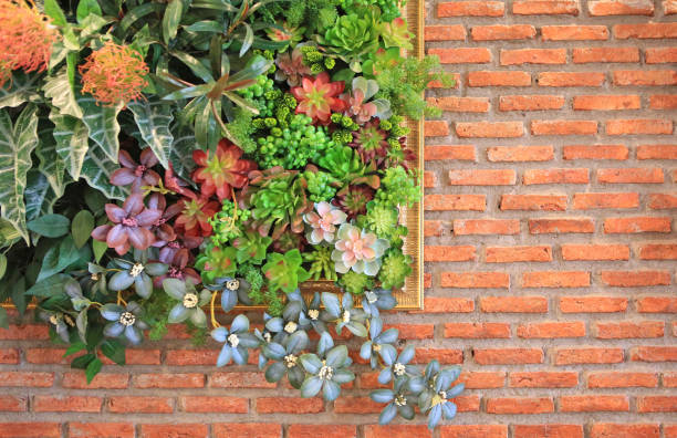 istock Beautiful plastic flower in frame decoration on brick wall background. 1137232797