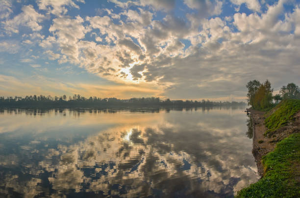 Spring foggy morning on the banks of the Neva river in Rybatskoye district in St. Petersburg.