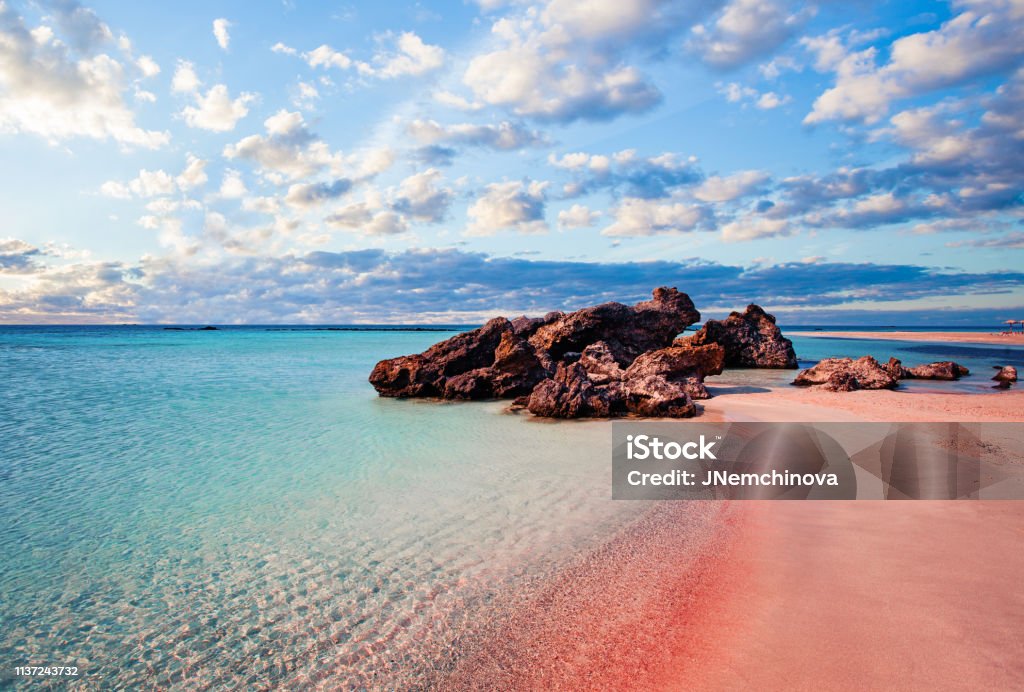 Crete skyline. Elafonissi beach with pink sand against blue sky with clouds on Crete, Greece Crete Stock Photo