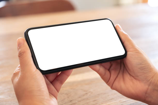 istock woman's hands holding black mobile phone with blank white screen horizontally 1137245689