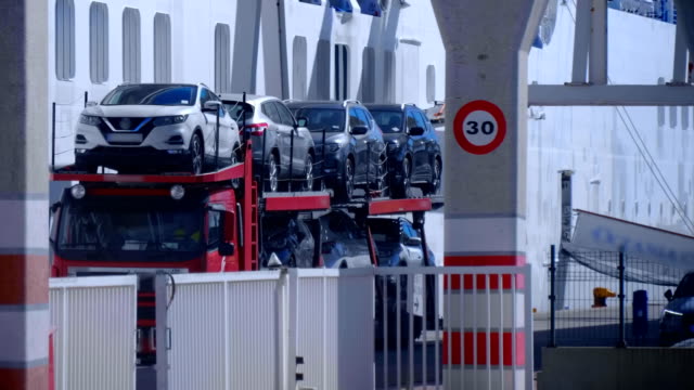 The car transporter leaves the territory of the cargo sea port of Valencia