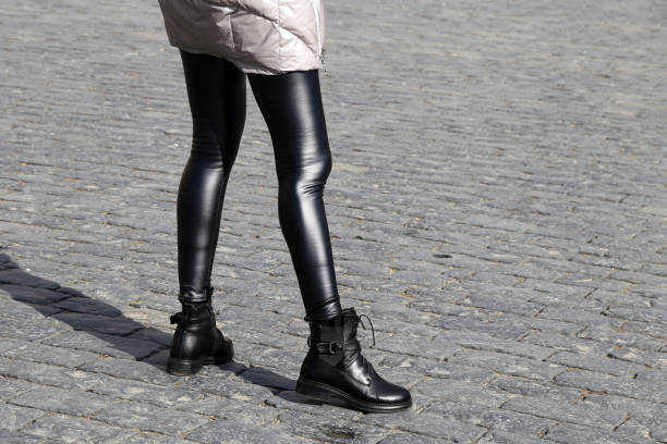 istock Slim female legs in leather leggings and boots 1137255436