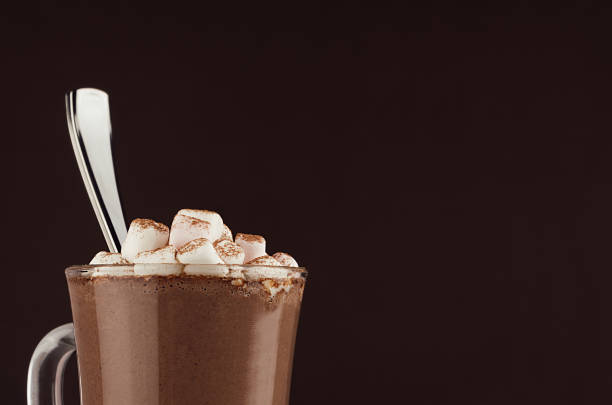 exquisite sweet hot chocolate drink with marshmallows and silver spoon closeup, top section, detail on dark brown background, copy space. - hot chocolate hot drink high section close up imagens e fotografias de stock