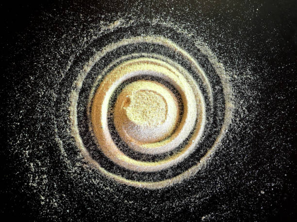 Sand spiral on the black background. The concept of rotation, golden ratio. stock photo