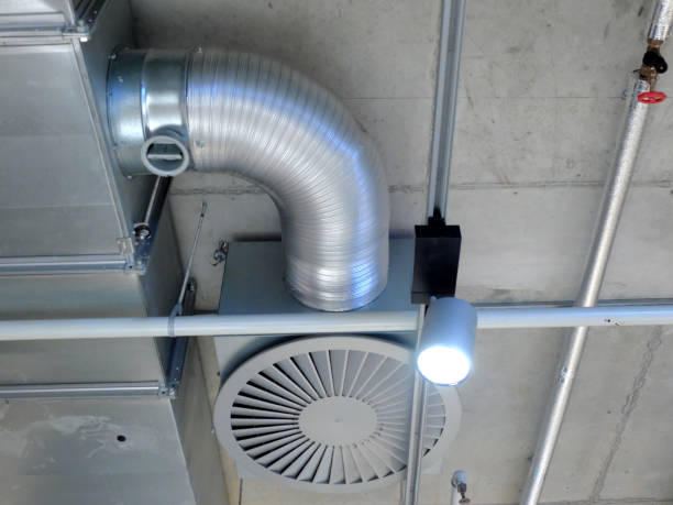 istock Ventilation system mounted on the concrete ceiling, ventilator, tube and a lamp. 1137259454