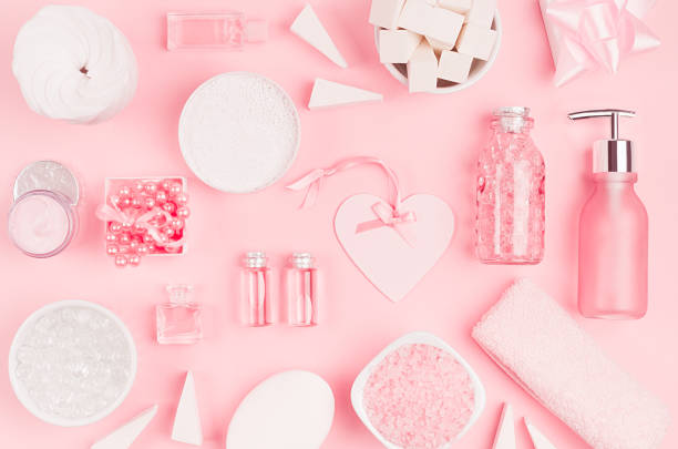 istock Different cosmetic products and accessories in pink and silver color as decorative pattern on soft light pink background, top view. 1137260887