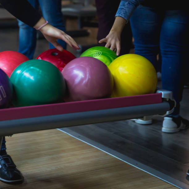 istock Hands choosing a bowling bowl. Close-up of bowling player hand taking ball 1137261843