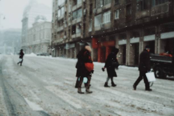 istock People Crossing Road In City During Snowfall 1137268358
