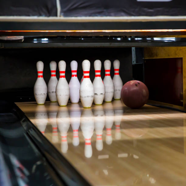 skittles and bowling ball on the playing field. activity concept - boliche de dez paus imagens e fotografias de stock