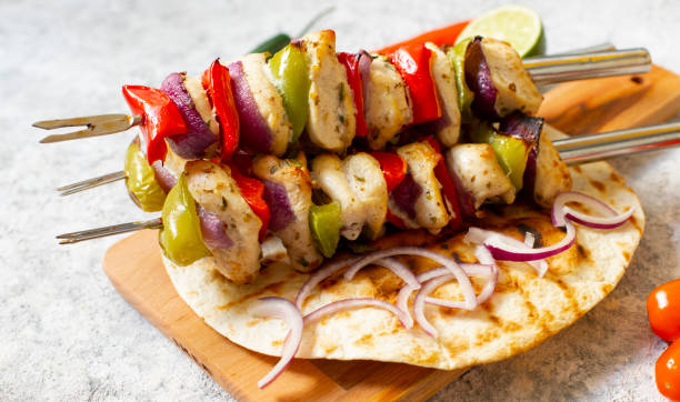 traditional greek grilled chicken souvlaki with pita bread. light background. close-up view - souvlaki imagens e fotografias de stock