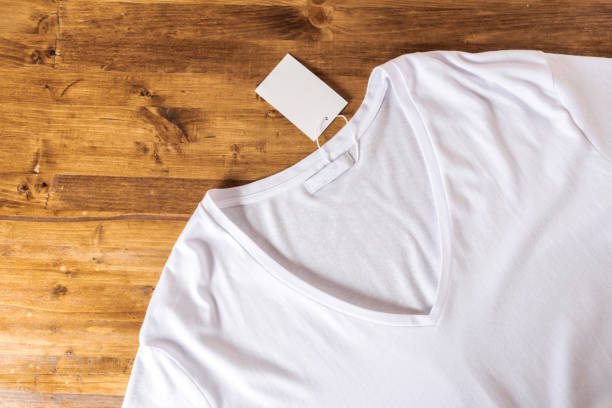 istock White t-shirt on a wooden background - 1137270799