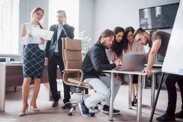 istock Colleagues communicate with work questions in modern office space. 1137272588