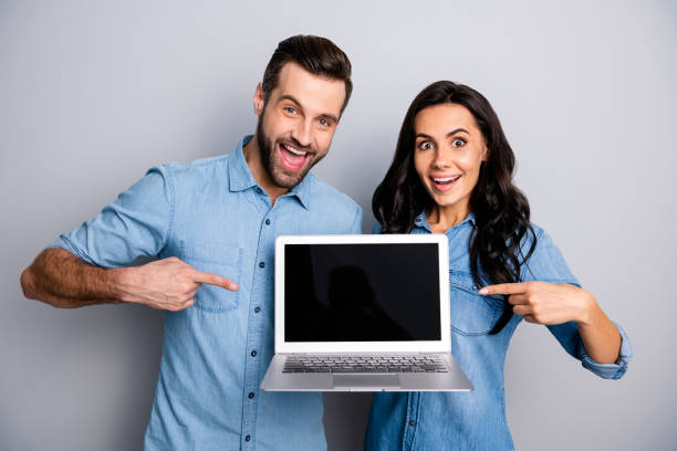 istock Close up photo beautiful amazing she her he him his lady guy direct indicate finger notebook new model recommend advise buy buyer wear casual jeans denim shirts outfit clothes isolated grey background 1137279612