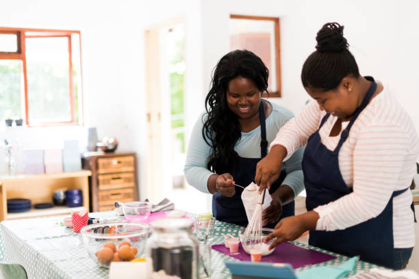 istock Two smiling women mixing flour together in their kitchen 1137280101