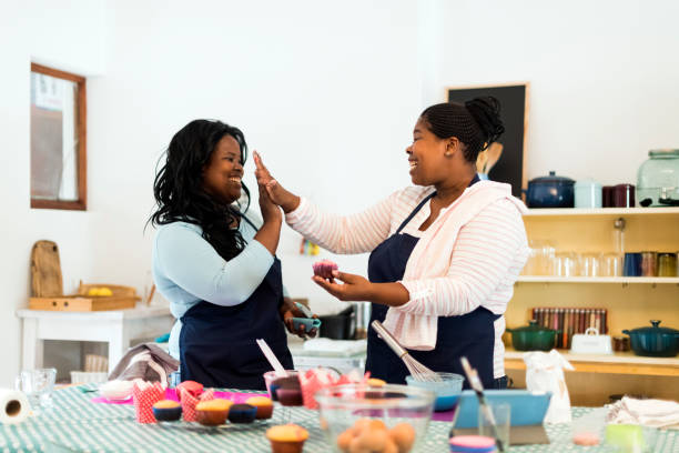 istock Women working together in their kitchen making cupcakes 1137280685