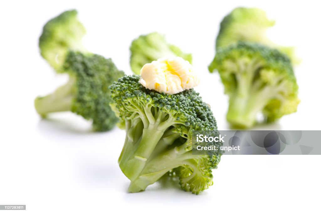 Green broccoli with butter as a garnish isolated on white background Broccoli Stock Photo