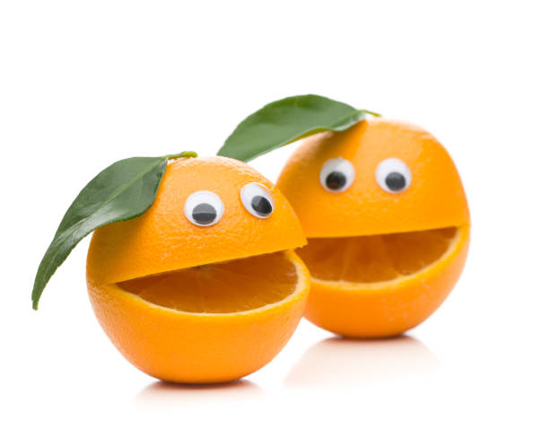 duas laranjas faladores com a folha isolada no fundo branco - isolated on white fun orange food - fotografias e filmes do acervo