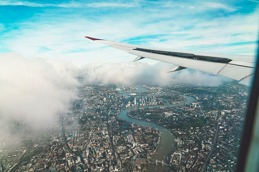 Aerial view of London from an airplane. Flying over London on a cloudy day.