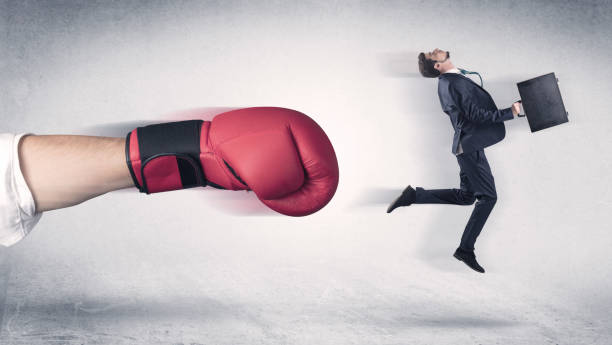 istock Businessman gets fired by a huge boxing hand 1137286539
