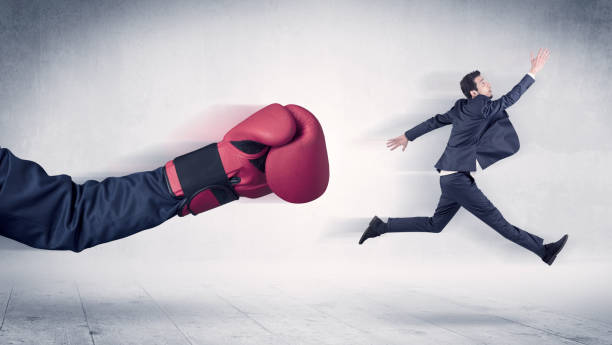 istock Huge Boxing Gloves punches businessman concept 1137286602