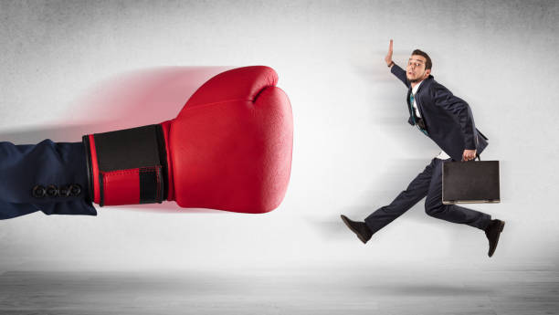 istock Big hand boxing little businessman 1137286678