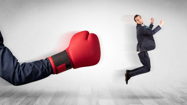 istock Red boxing glove knocks out little businessman 1137286780