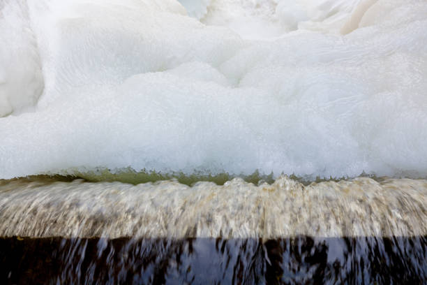 Dam at winter flowing water and ice formations