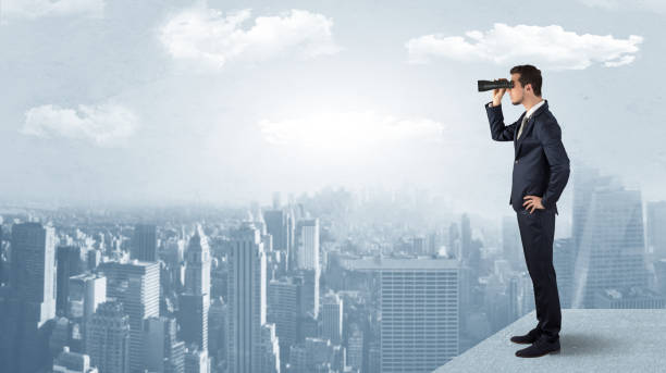 istock Man looking forward from the top of a skyscraper 1137289170