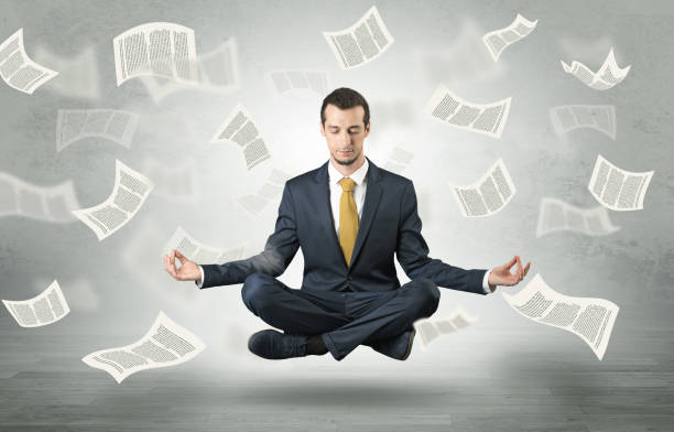 istock Businessman meditating with flying paper concept 1137289695
