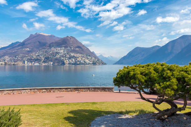 the picturesque lakeside city of lugano is famous for its beautiful quasi-mediterranean scenery - ticino canton mountain lake lugano lake imagens e fotografias de stock