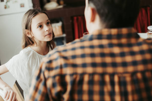 istock Selective focus of curious girl looking at her father 1137294037