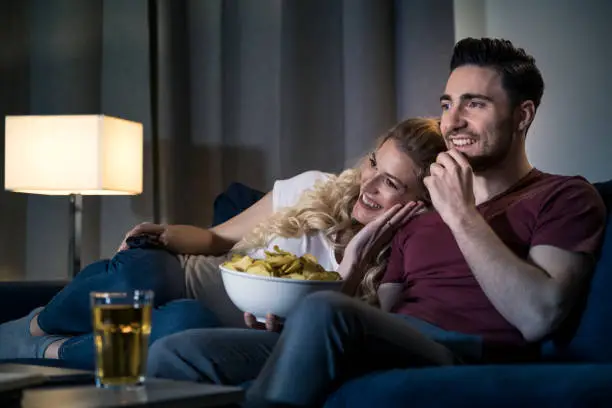 Photo of Couple watching movie at home