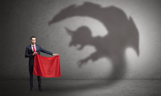 istock Businessman with imp shadow and toreador concept 1137295217