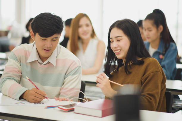 istock Seminar meeting room with many audiences for business concept, Professional education, work meeting, presentation or coaching, focus on young Asian men and woman which discussion and writing a book 1137295228