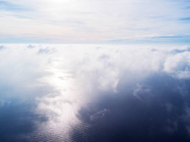 Aerial view White clouds in blue sky. Top view. View from drone. Aerial bird's eye view. Aerial top view cloudscape. Texture of clouds. View from above. Sunrise over the sea Aerial view White clouds in blue sky. Top view. View from drone. Aerial bird's eye view. Aerial top view cloudscape. Texture of clouds. View from above. Sunrise over the sea stratosphere airplane cloudscape mountain stock pictures, royalty-free photos & images