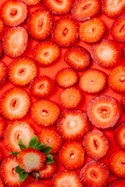 istock strawberry slice on red background. sliced strawberries 1137296861
