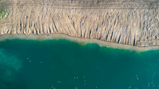 istock Abstract lakeshore, abandoned gravel pit - aerial view 1137297596