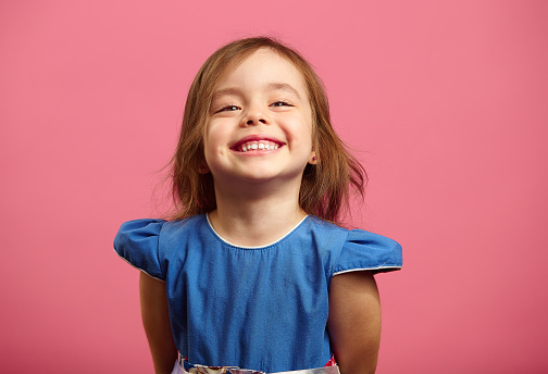 Girl in a white dress and in a white photo studio