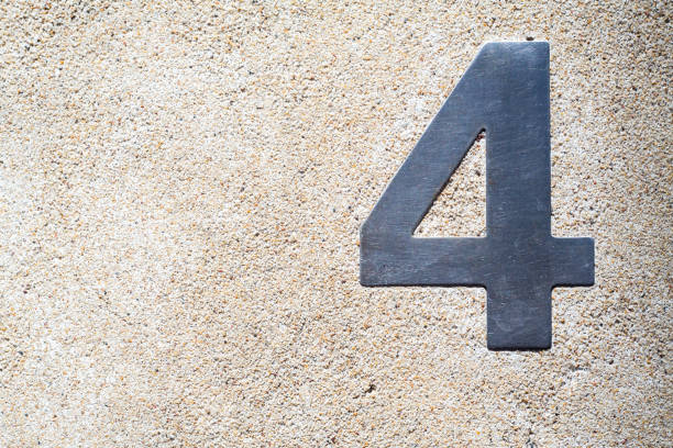Number 4 (Four) made  from galvanized iron on small stones concrete  texture background, Close up and macro shot, Selective focus