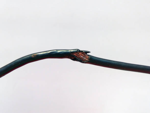 istock Damaged black electric cord on white background. Dangerous broken power electrical cable 1137302051